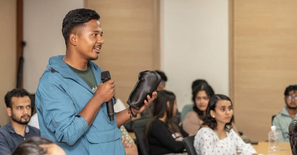 A young founder asking a question during David Swicegood's session on monetizing AI solutions in Nepal